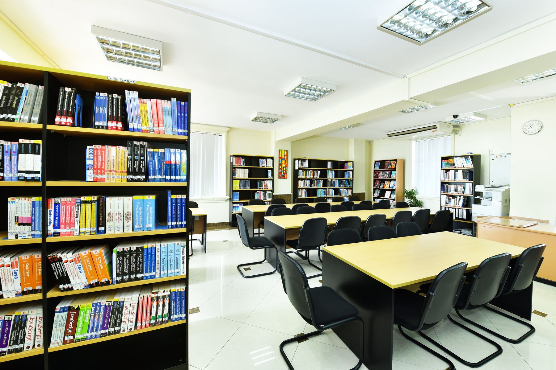 The library reading room, with study tables and the computer science shelves